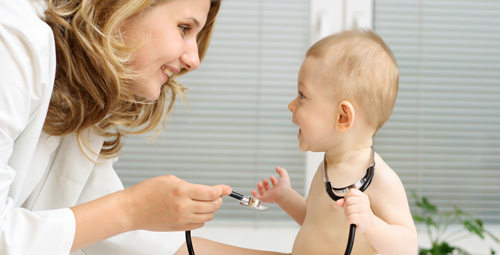 Doctor showing a stetthoscope to a baby